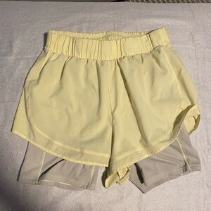 CALIA by Carrie Underwood High-Rise 2-in-1 Running Shorts in a yellow